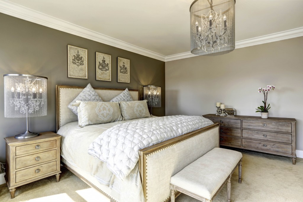 Luxury bedroom interior with carved wood bed, dresser and nightstands