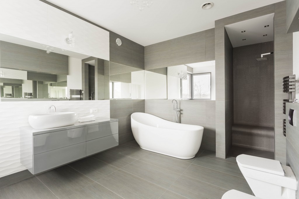 White and grey exclusive big washroom with fancy bath